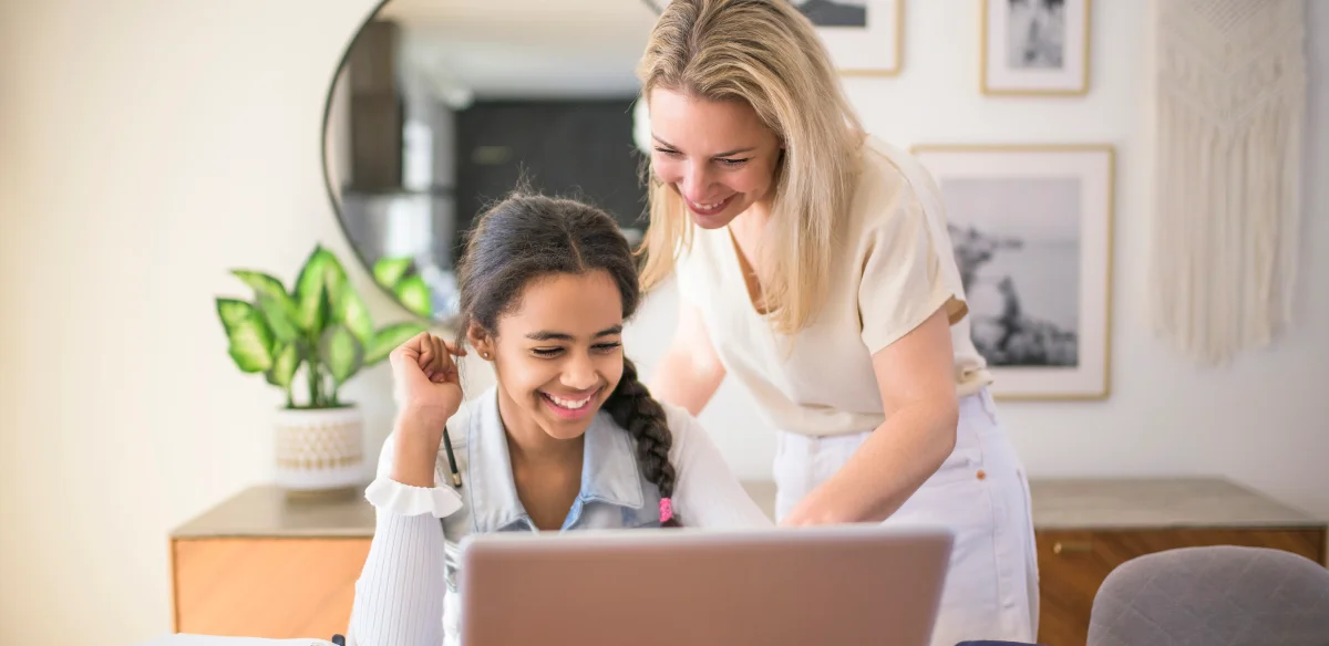 Mother and daugther using their laptop